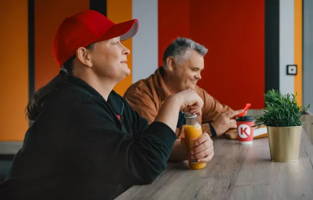 Man and woman relaxing in Circle K with snacks